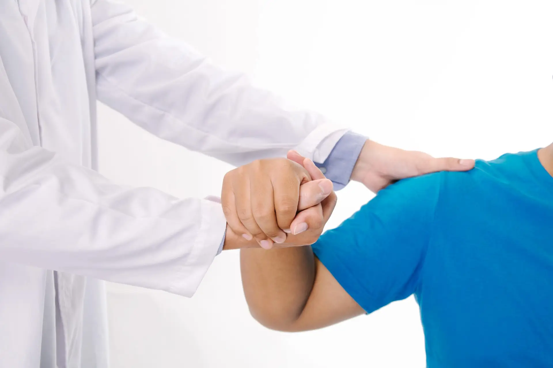 Doctor physiotherapist consulting with patient about shoulder muscle pain problems in clinic medical office.