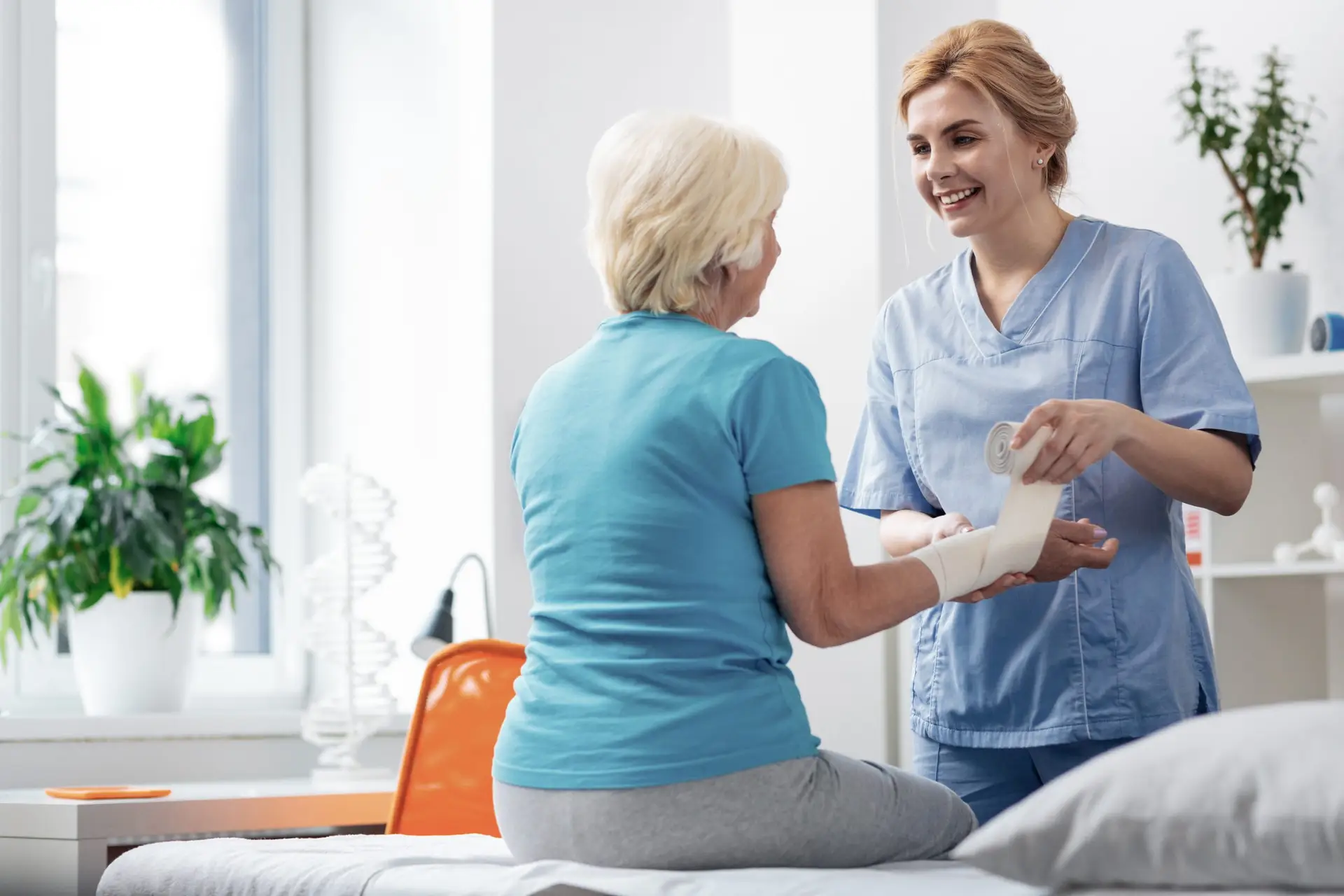 Cheerful professional nurse cheering up her patient